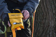 Harkie tree climbing first aid kit in yellow pouch held by arborist on harness beside climbing ropes